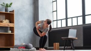 Woman doing twisted chair pose to reduce stress